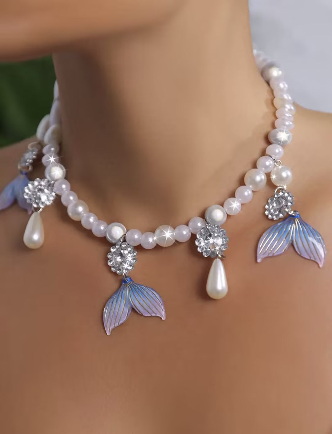 Bold, statement-style layered faux-pearl necklace with tassels—a short, collarbone-length piece for women.