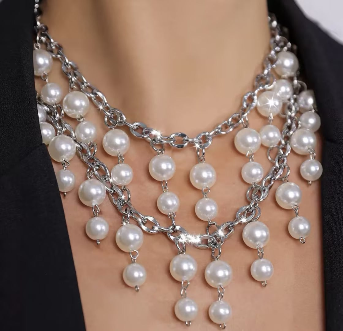 Bold, statement-style layered faux-pearl necklace with tassels—a short, collarbone-length piece for women.
