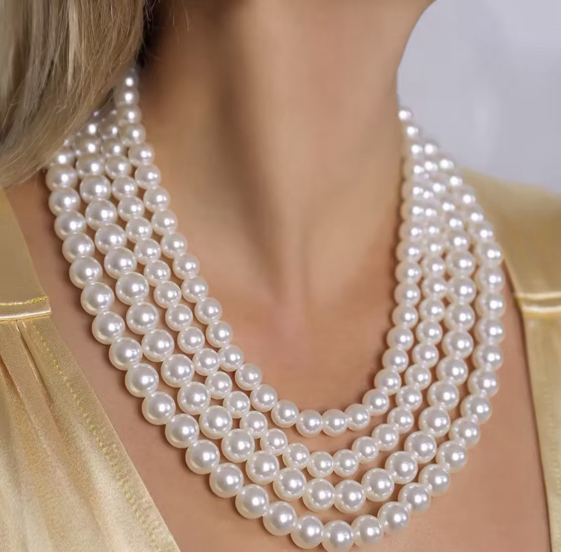 Bold, statement-style layered faux-pearl necklace with tassels—a short, collarbone-length piece for women.